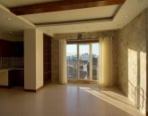 سالن نشیمن با کاغ دیواری کرم و سقف کاذب چوبی آپارتمان در نصیرآباد تنکابن 541211